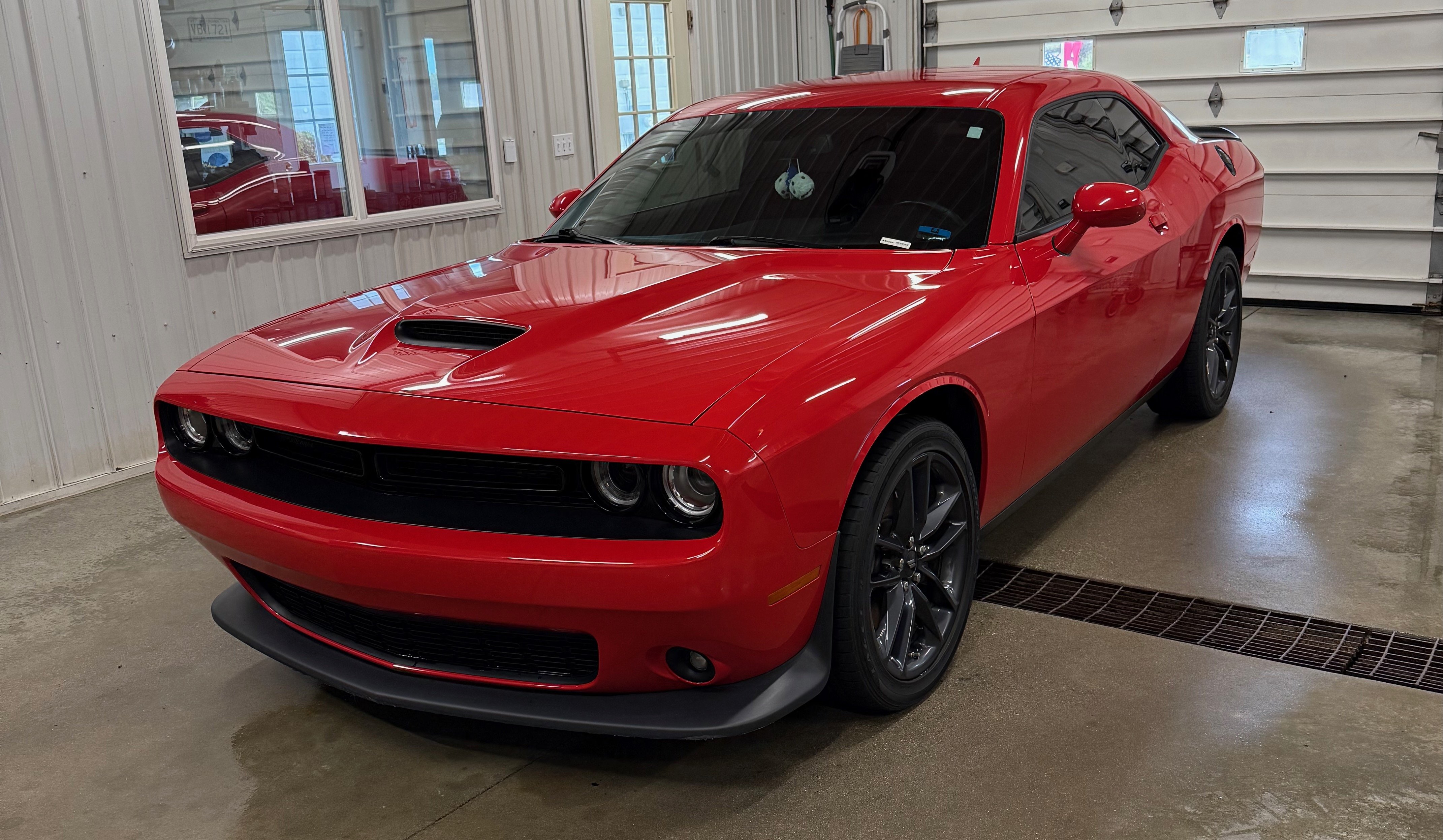 Red Dodge Challenger freshly detailed at Clifton's Detail Shop Shepherd MI